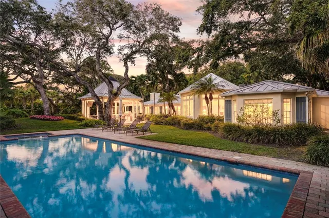 a view of swimming pool with trees in a patio