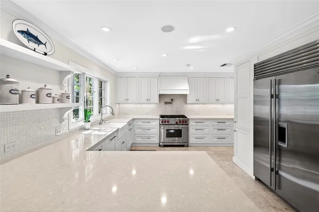 a large kitchen with stainless steel appliances and a stove