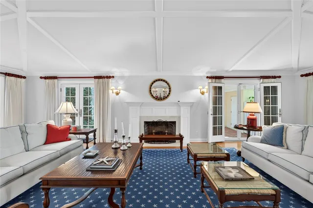 a living room with furniture a fireplace and window
