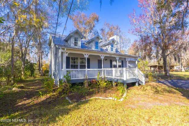 a front view of a house with a yard table and chairs