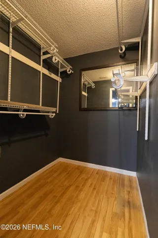 an empty room with wooden floor and a window