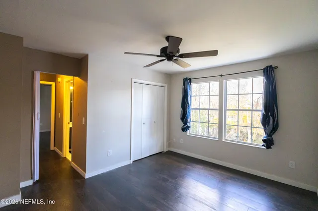 a bathroom with a sink a toilet a mirror and shower curtain