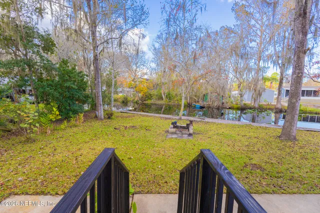 a view of a yard with swimming pool