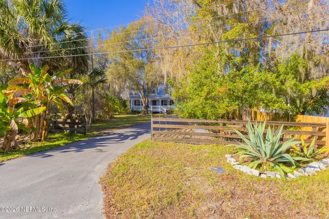 an aerial view of a houses with a yard