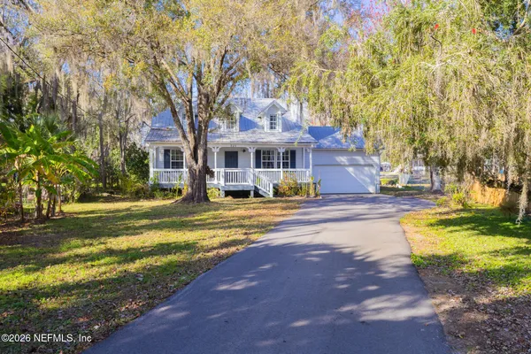 an aerial view of residential houses with outdoor space and swimming pool