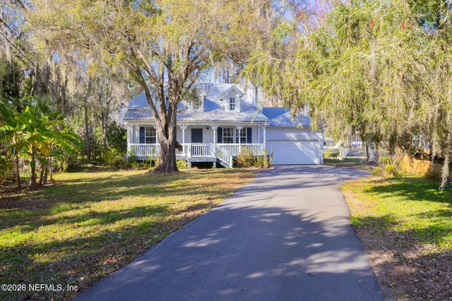 an aerial view of residential houses with outdoor space and swimming pool