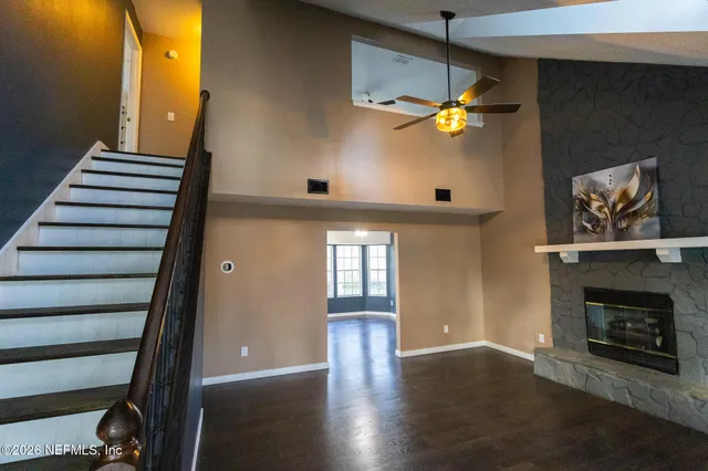 wooden floor in an empty room with a fireplace