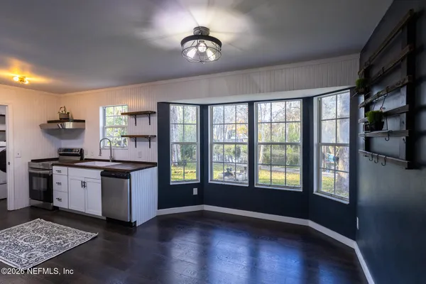a kitchen with stainless steel appliances a refrigerator and a stove top oven