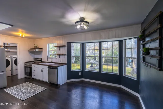 a kitchen with cabinets and stainless steel appliances