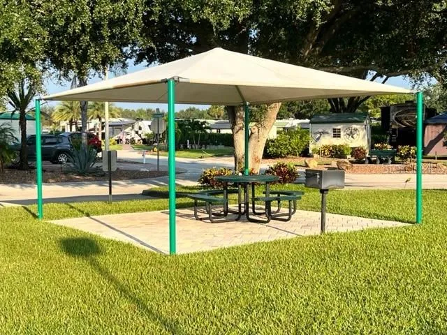 a view of a patio with a table chairs and backyard