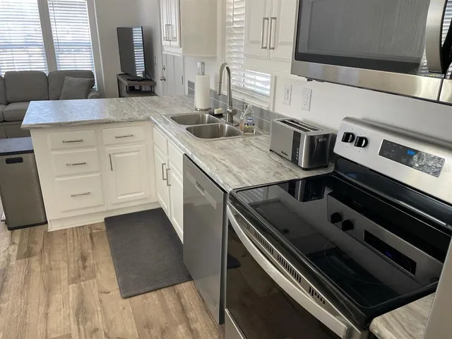 a kitchen with a stove microwave and sink