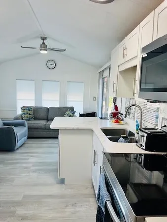 a kitchen with a sink appliances and cabinets