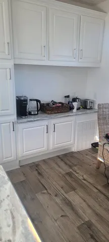 a kitchen with stainless steel appliances granite countertop a sink and a stove