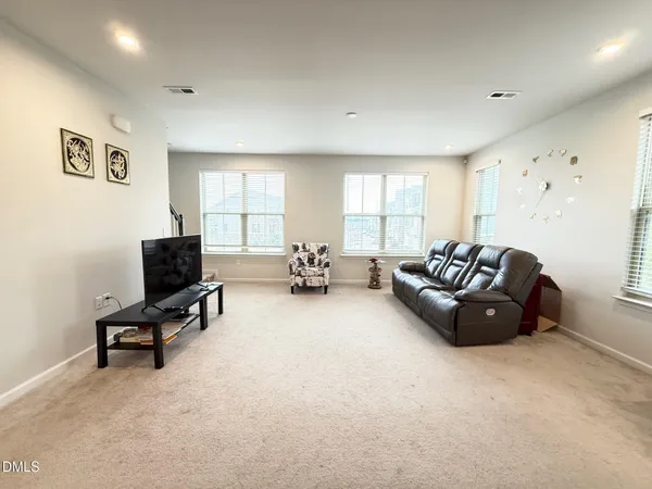 a living room with furniture window and a flat screen tv