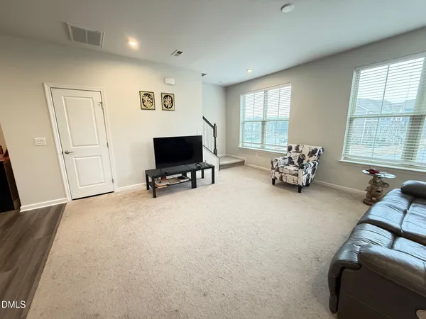 a view of a livingroom with lounge chair and a window