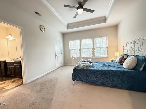 a spacious bedroom with a bed and window