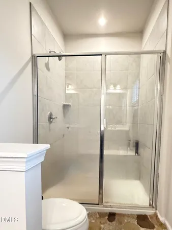 a bathroom with a shower and a toilet
