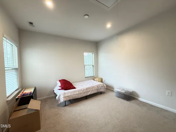 a bedroom with a bed and window