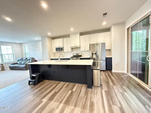 a kitchen with a refrigerator and a sink