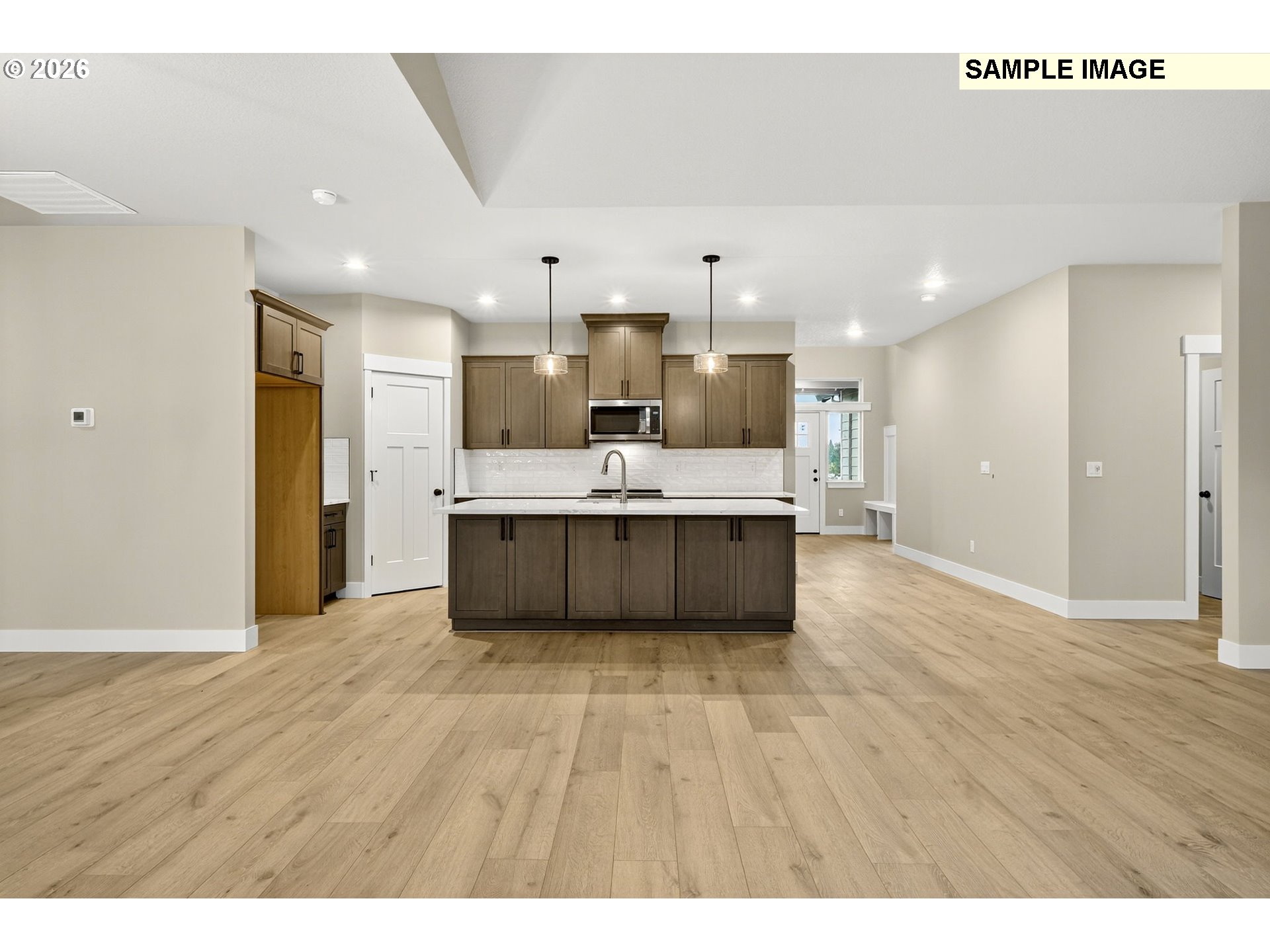 3352 Northeast Sweetwater Road, Unit 80 Estacada, OR 97023 - Photo 13 of 48 a large kitchen with stainless steel appliances kitchen island a large counter top and wooden floors