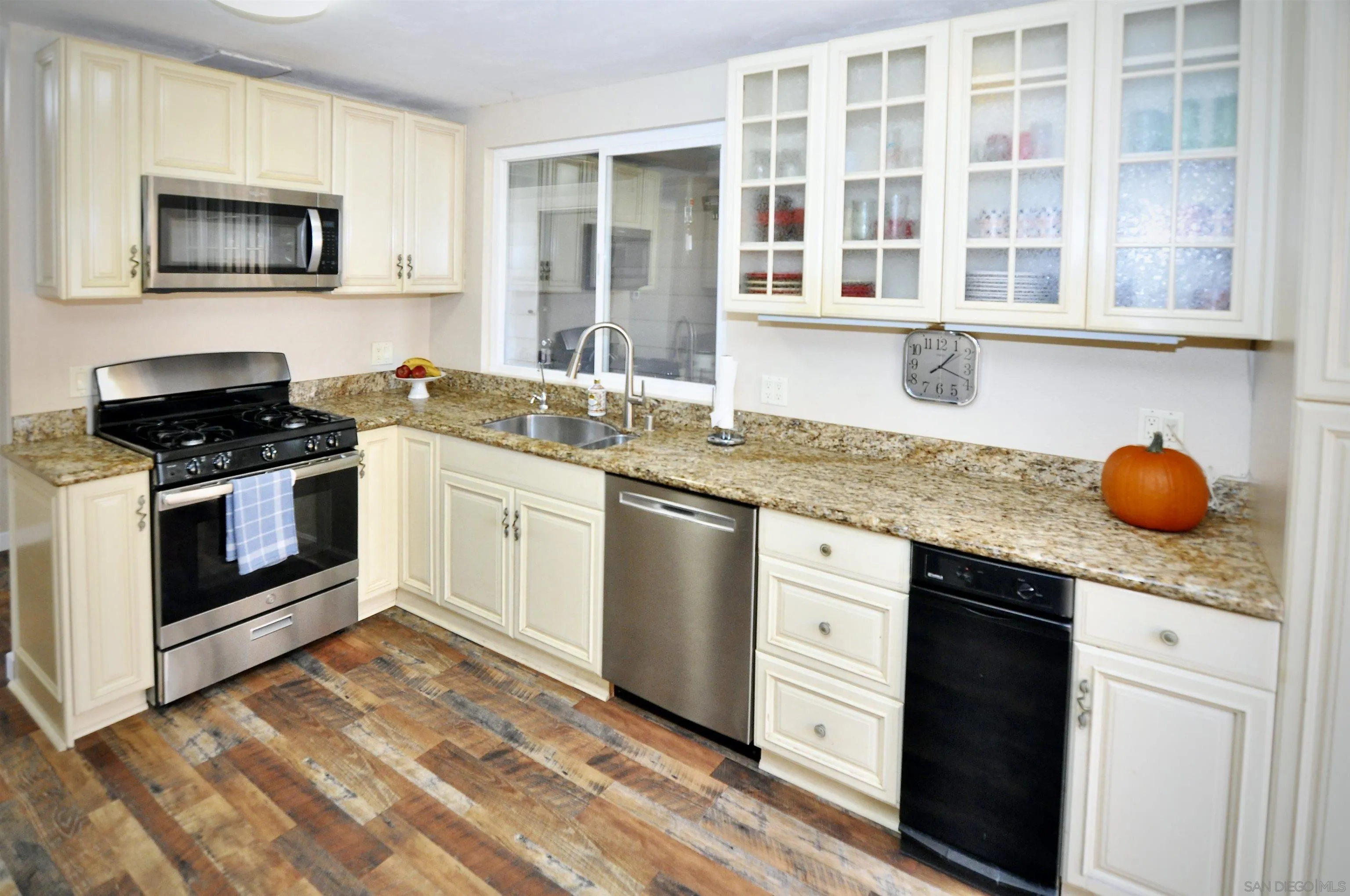 14333 Lolin Lane Poway, CA 92064 - Photo 14 of 41 a kitchen with stainless steel appliances granite countertop a stove a sink and a microwave