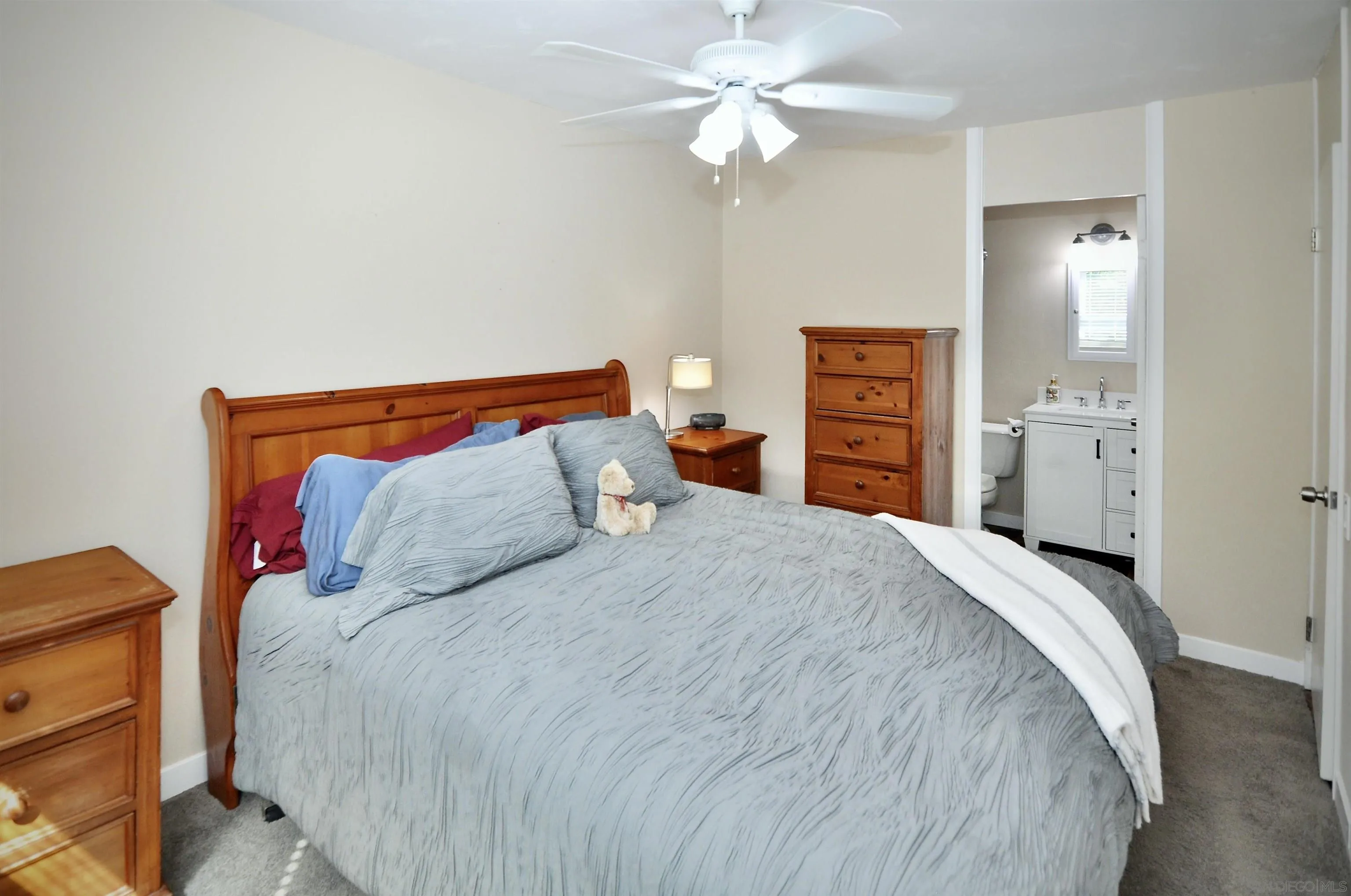 14333 Lolin Lane Poway, CA 92064 - Photo 20 of 41 a bedroom with a bed and a chandelier