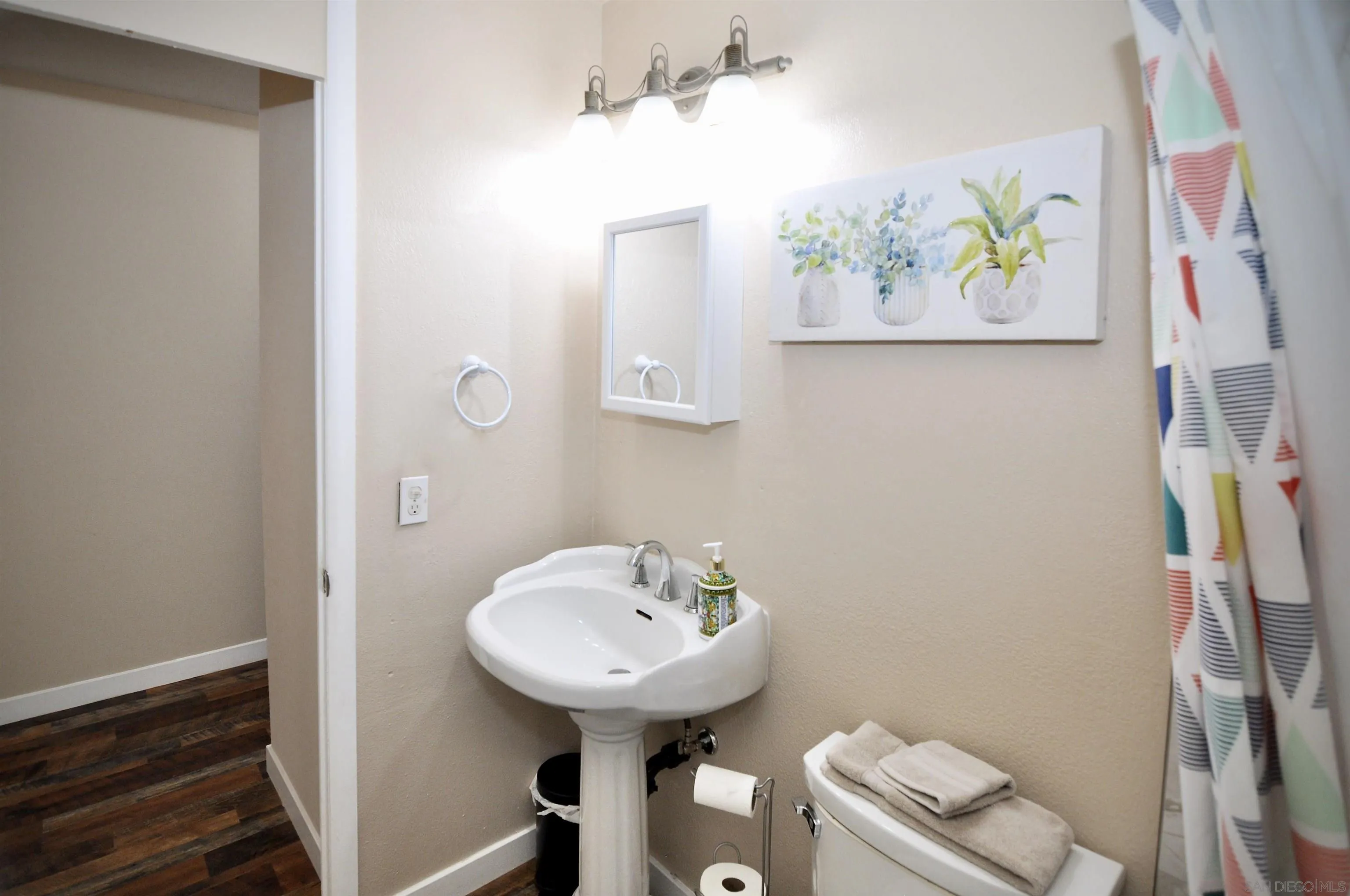 14333 Lolin Lane Poway, CA 92064 - Photo 25 of 41 a bathroom with a sink a toilet and mirror