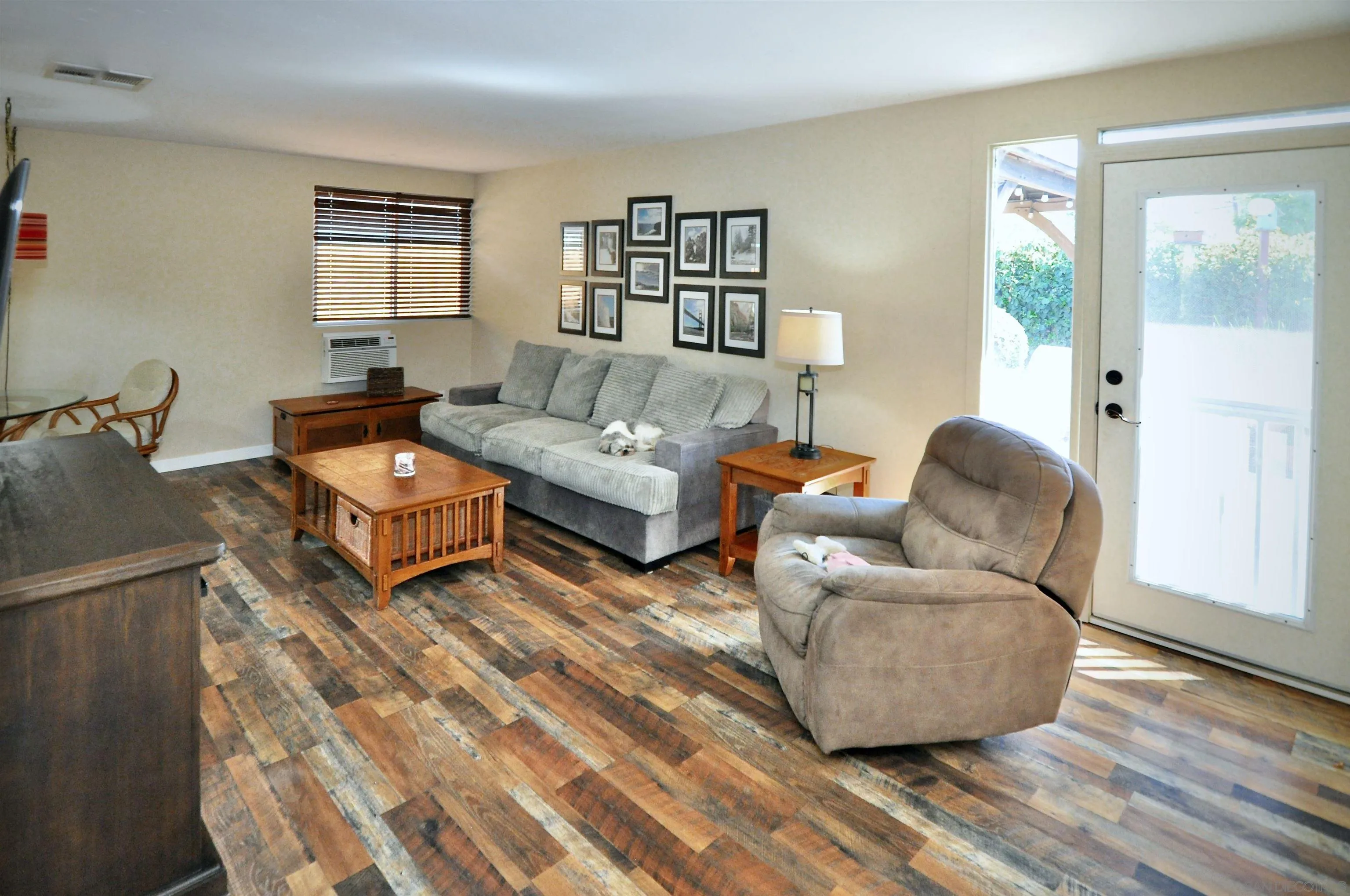 14333 Lolin Lane Poway, CA 92064 - Photo 27 of 41 a living room with couches and a night stand with wooden floor