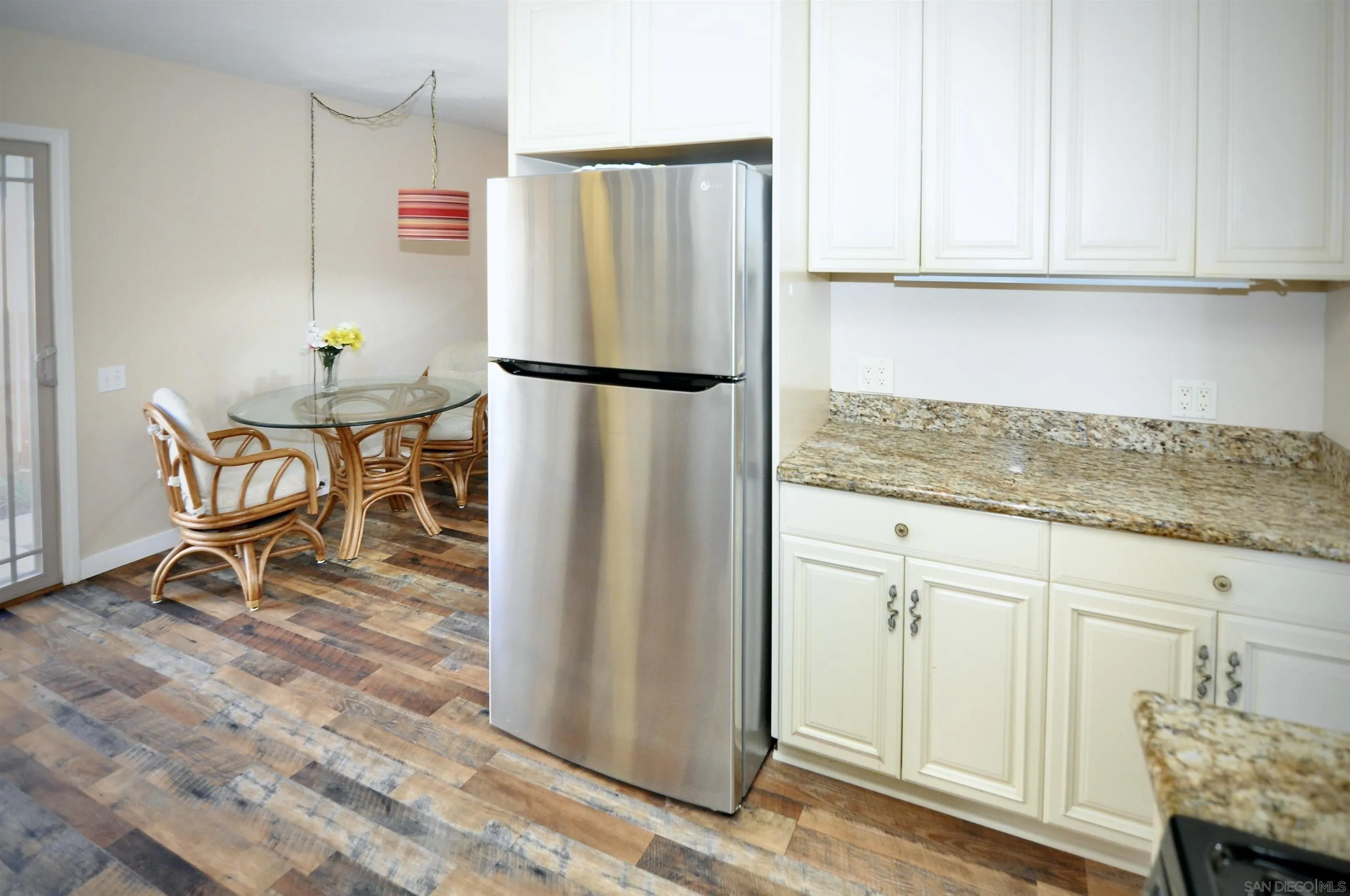 14333 Lolin Lane Poway, CA 92064 - Photo 33 of 41 a kitchen with granite countertop a refrigerator and a cabinets