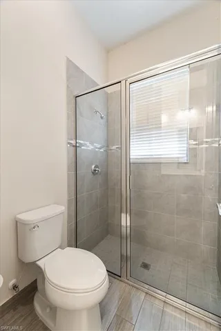 a bathroom with a shower and a toilet