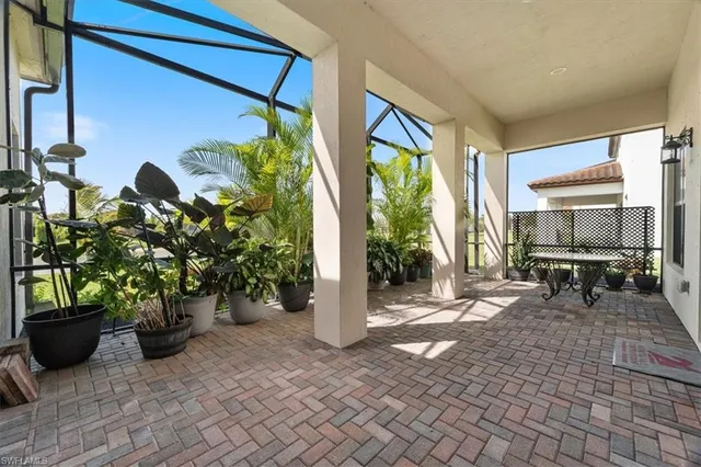 a view of a porch with chairs and potted plants