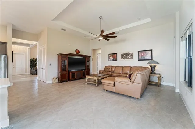 a living room with furniture and a ceiling fan