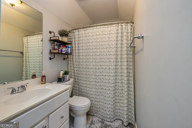 a bedroom with a bed and a book shelf