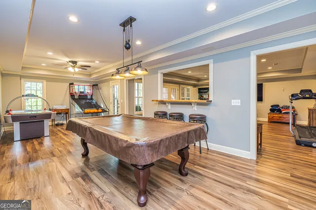 an aerial view of residential house with outdoor space and trees all around