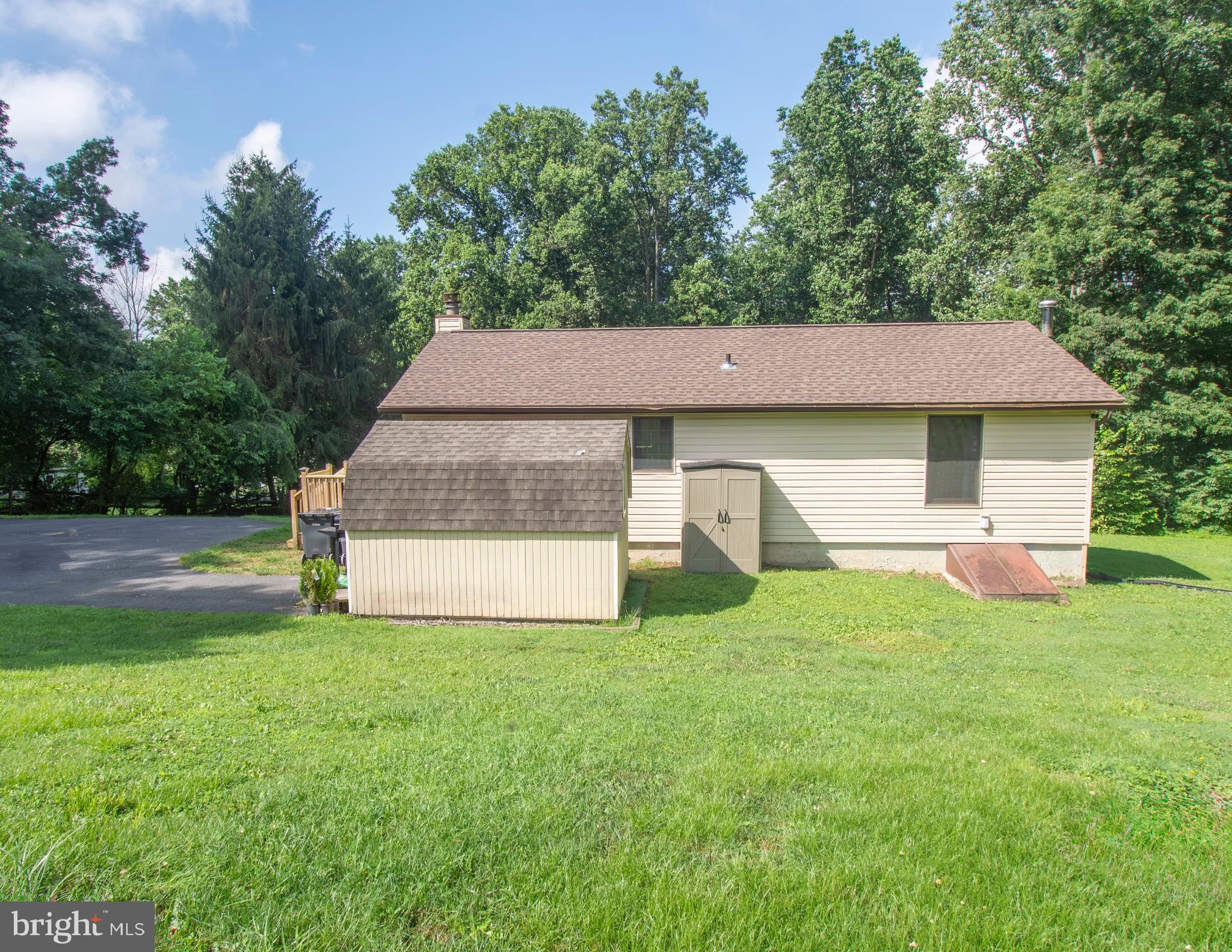185 Codjus Drive Rising Sun, MD 21911 - Photo 5 of 17 a house that is sitting in the grass with large trees