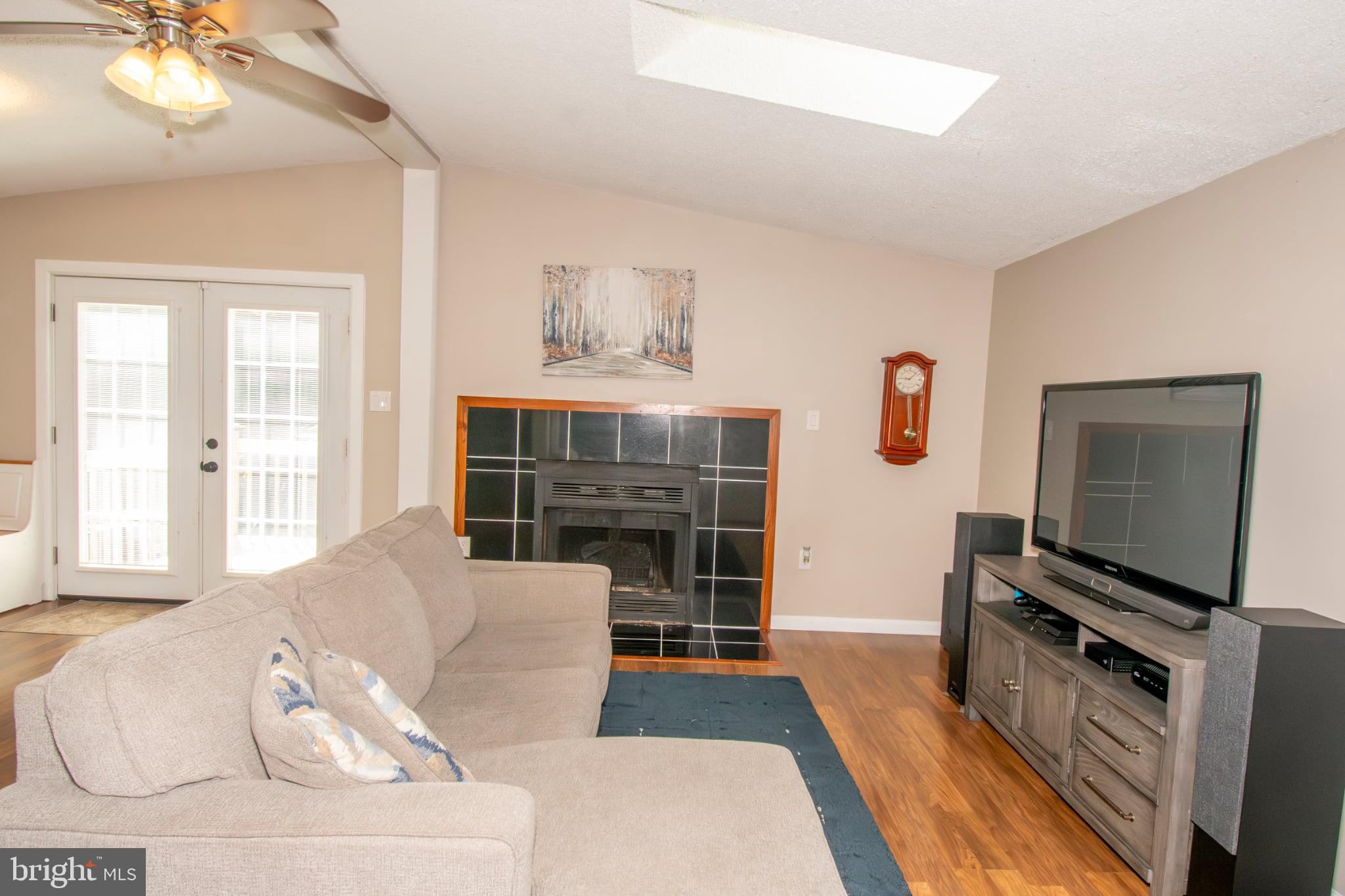 185 Codjus Drive Rising Sun, MD 21911 - Photo 8 of 17 a living room with furniture a fireplace and a flat screen tv