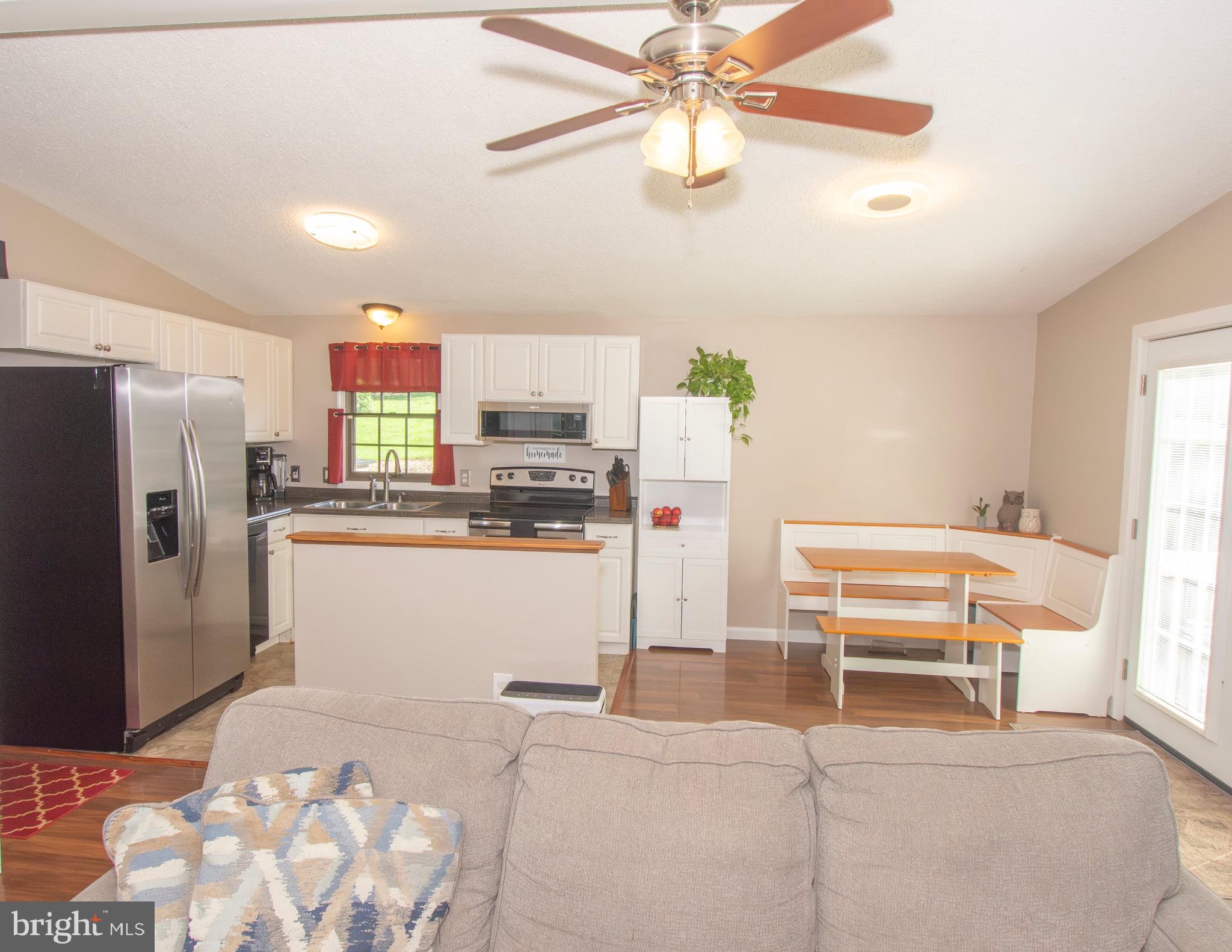 185 Codjus Drive Rising Sun, MD 21911 - Photo 10 of 17 a kitchen with stainless steel appliances kitchen island granite countertop a refrigerator and a stove top oven