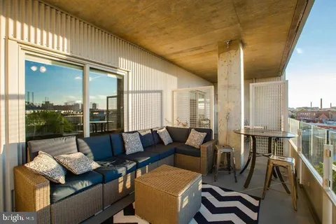 a living room with furniture and a floor to ceiling window