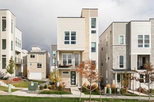 a front view of a residential apartment building with a yard