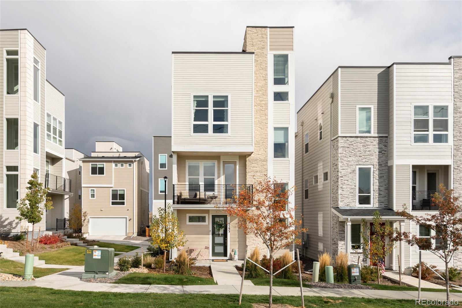 5293 North Quail Street Arvada, CO 80002 - Photo 1 of 1 a front view of a residential apartment building with a yard