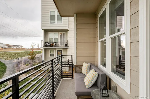 a view of a balcony with chair and wooden floor