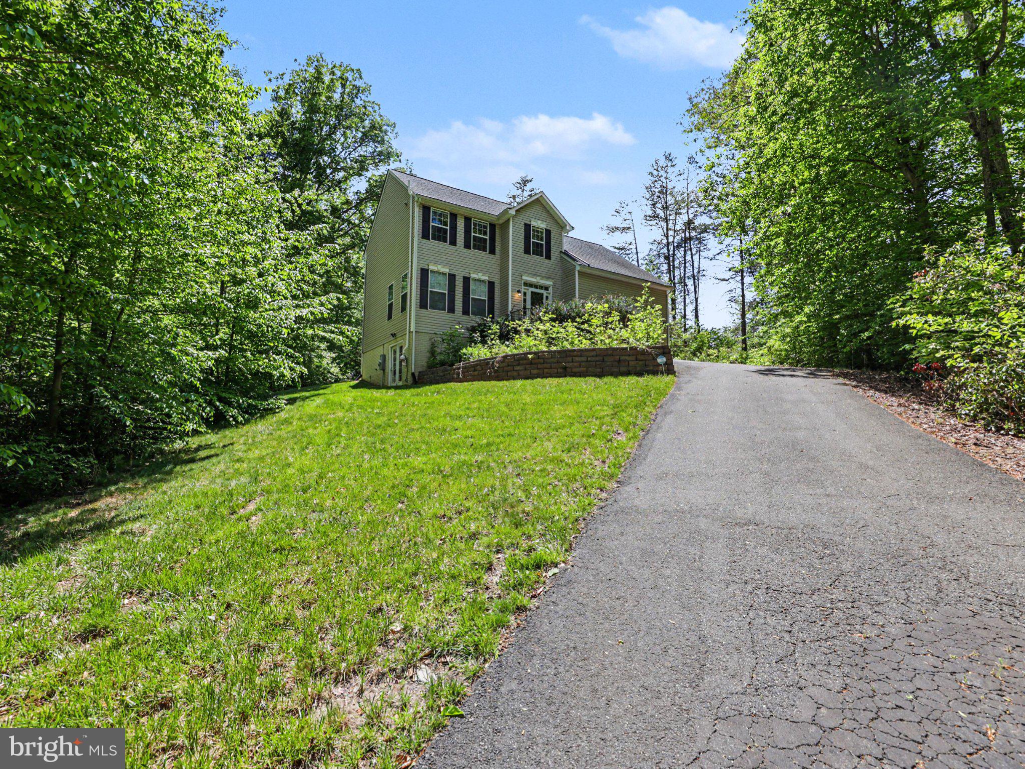 9811 Catharpin Road Spotsylvania, VA 22551 - Photo 2 of 30 a front view of a house with a yard and trees