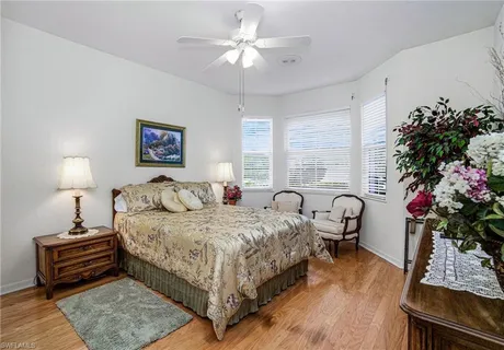 a bedroom with a bed potted plant and a window