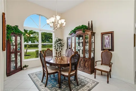 a view of a dining room with furniture wooden floor and chandelier