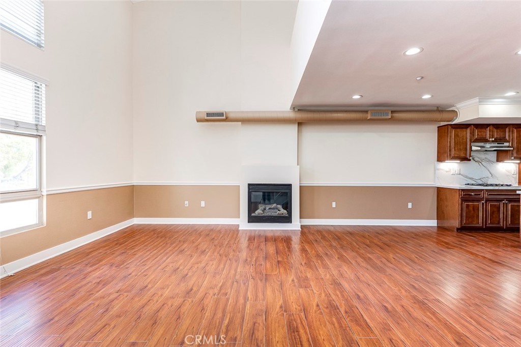 596 South Brea Boulevard Brea, CA 92821 - Photo 4 of 33 an empty room with wooden floor and windows