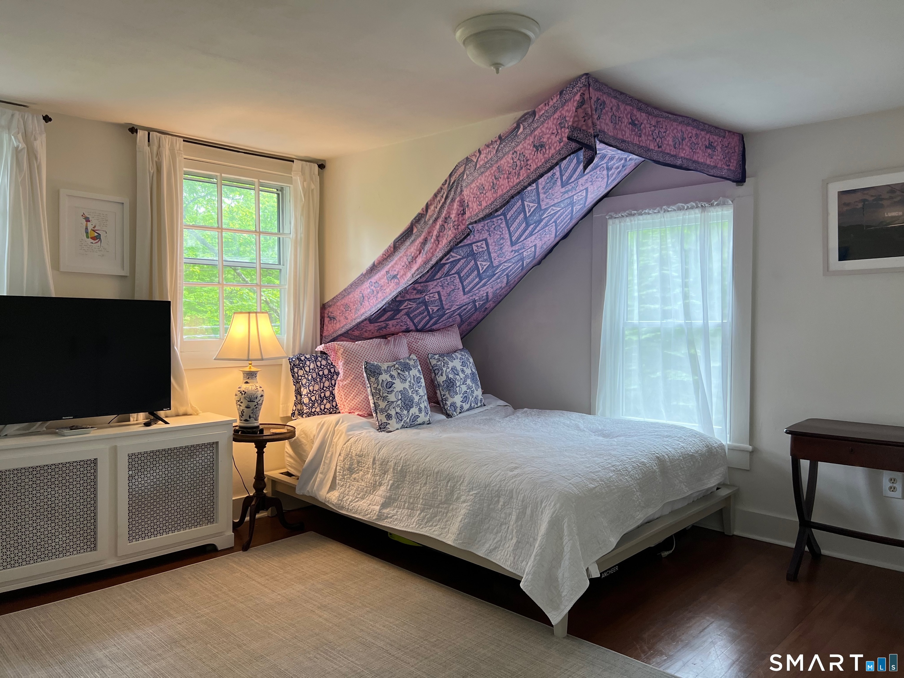 269 Farmingville Road Ridgefield, CT 06877 - Photo 13 of 17 a bedroom with a bed and a flat screen tv