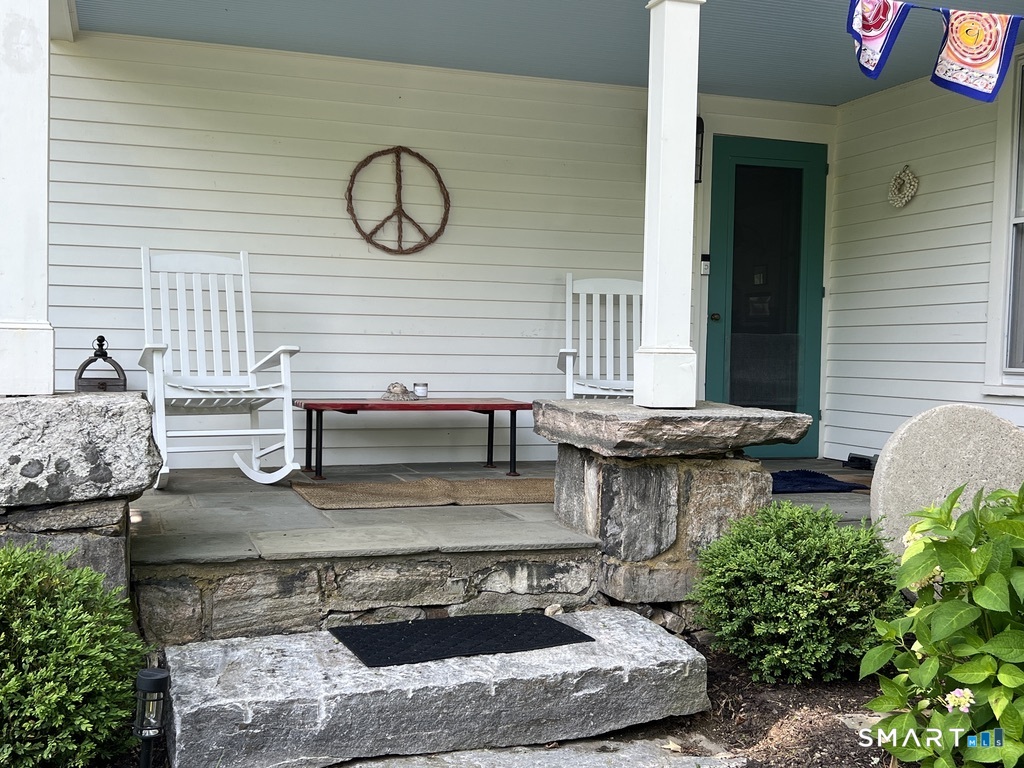 269 Farmingville Road Ridgefield, CT 06877 - Photo 3 of 17 a view of a house with back yard porch and furniture