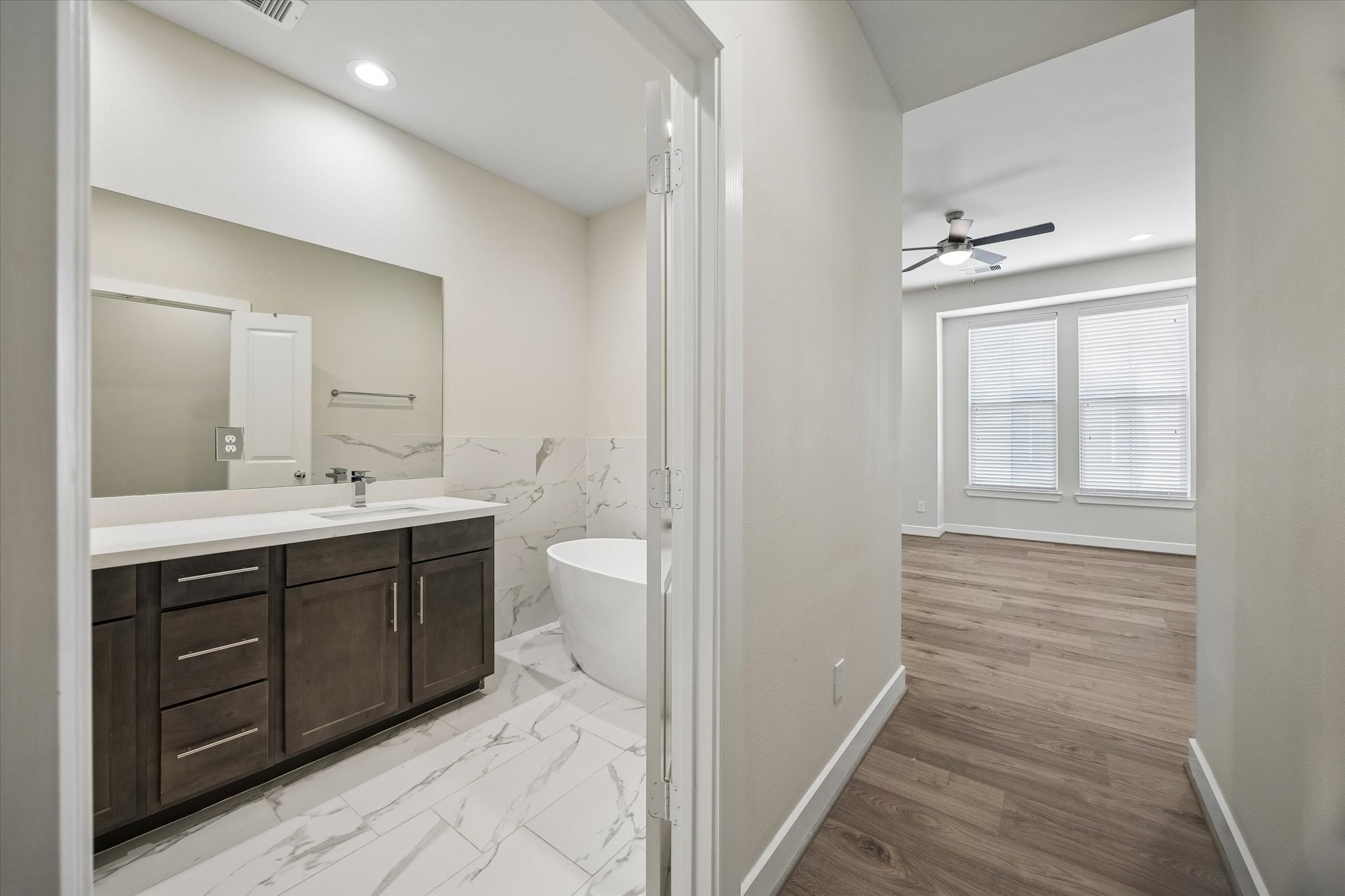 5914 Haring Lane Houston, TX 77091 - Photo 9 of 11 a bathroom with a double vanity sink a toilet and a mirror