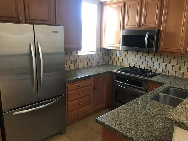 a view of kitchen island wooden floor and a sink