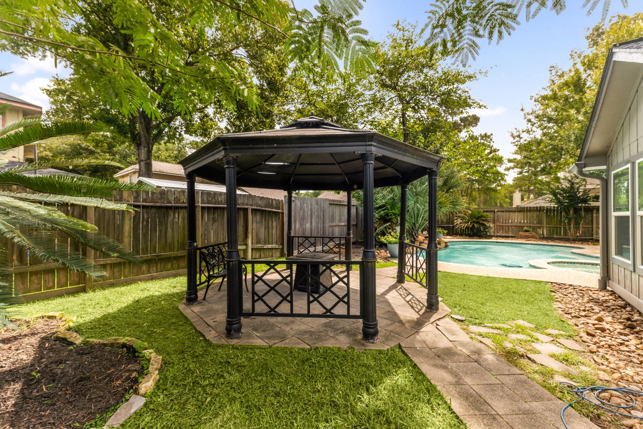 1915 Mercoal Drive Spring, TX 77386 - Photo 33 of 50 Beautiful backyard showcasing the gazebo, pool area, and plenty of green space.